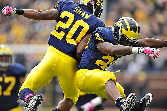 Michael Shaw (20) and Fitzgerald Toussaint (28)