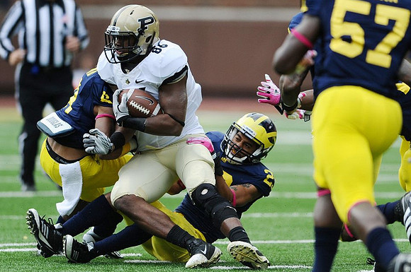 J.T. Floyd (8), Troy Woolfolk (29), and Frank Clark (57)