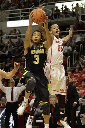 Trey Burke (3) and Bradley Head coach Geno Ford