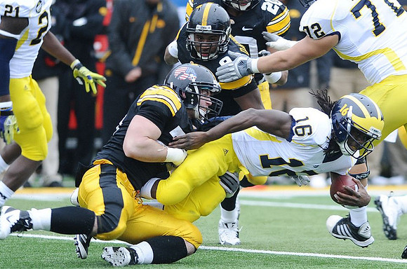 Junior Hemingway (21), Denard Robinson (16), and Mark Huyge (72)