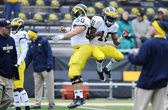 Devin Gardner (7), David Molk (50), and Denard Robinson (16)