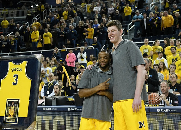 Zavier Simpson (3) and Jon Teske (15)