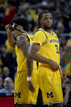 Eli Brooks (55) and Zavier Simpson (3)