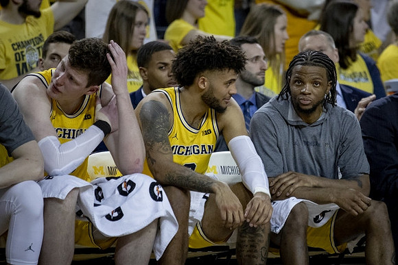 Jon Teske (15), Isaiah Livers (2), and Zavier Simpson (3)