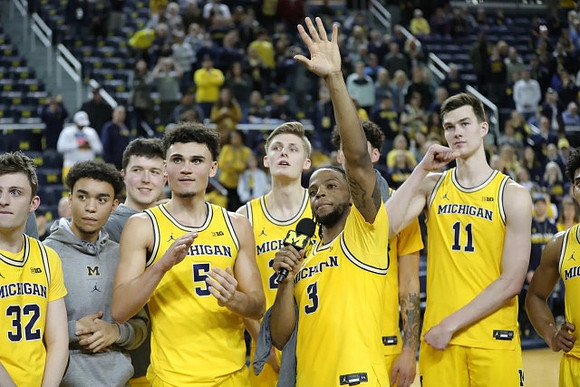Zavier Simpson (3) and Michigan Team