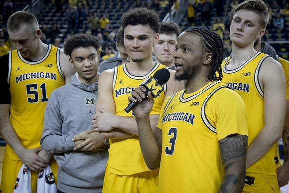 Zavier Simpson (3) and Michigan Team