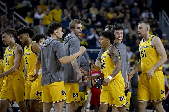 Eli Brooks (55), Austin Davis (51), and Michigan Team