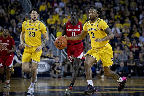 Brandon Johns Jr. (23) and Zavier Simpson (3)