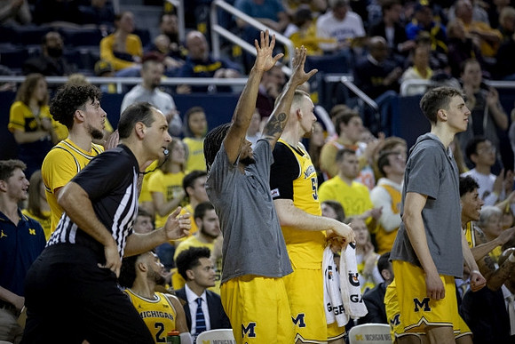 Brandon Johns Jr. (23), Zavier Simpson (3), Austin Davis (51), and Franz Wagner (21)