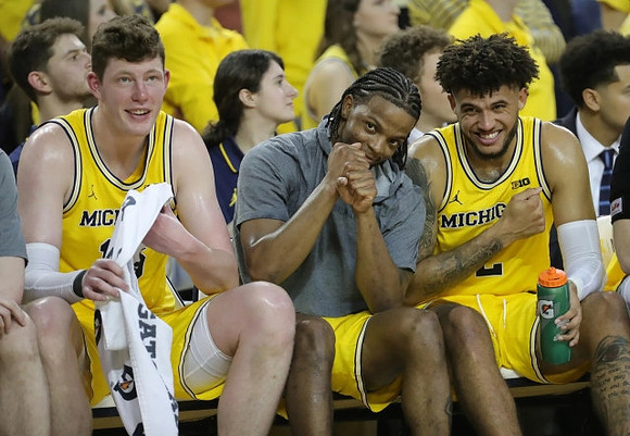 Jon Teske (15), Zavier Simpson (3), and Isaiah Livers (2)