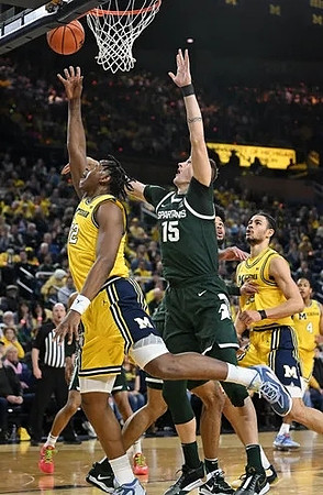 Tarris Reed Jr. (32), Olivier Nkamhoua (13), and Nimari Burnett (4)