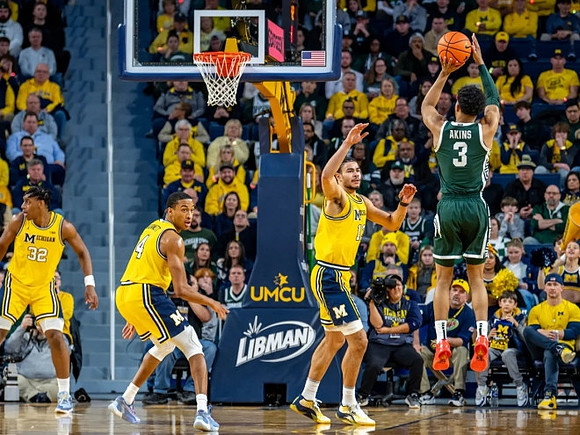Tarris Reed Jr. (32), Nimari Burnett (4), and Olivier Nkamhoua (13)
