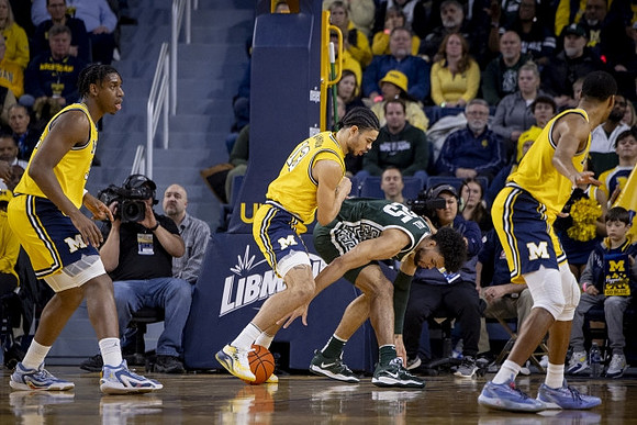 Tarris Reed Jr. (32), Olivier Nkamhoua (13), and Nimari Burnett (4)