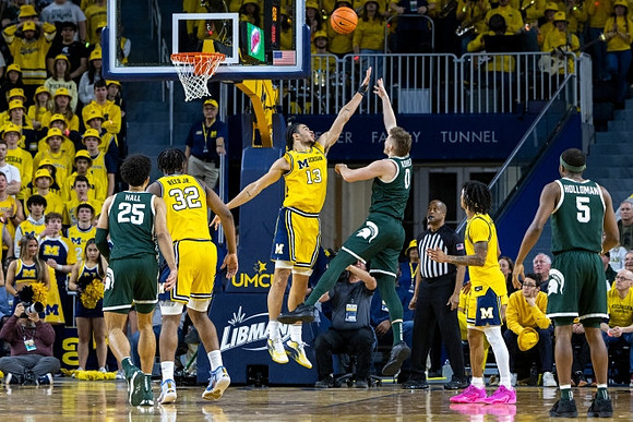 Tarris Reed Jr. (32), Olivier Nkamhoua (13), and Dug McDaniel (0)