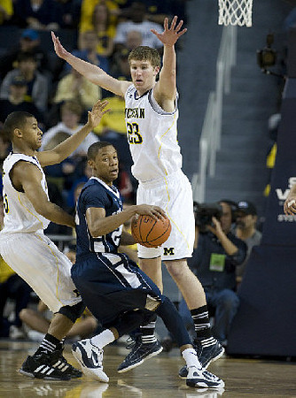 Trey Burke (3) and Evan Smotrycz (23)