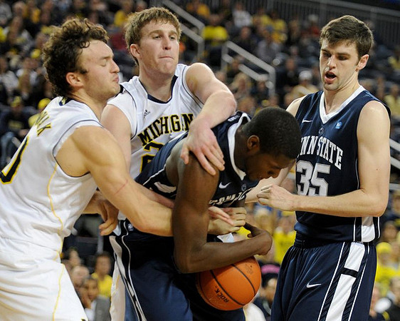 Zack Novak (0) and Evan Smotrycz (23)