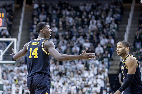 Moussa Diabate (14) and DeVante' Jones (12)