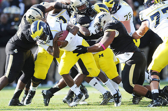 Denard Robinson (16), Michael Schofield (75), and Taylor Lewan (77)