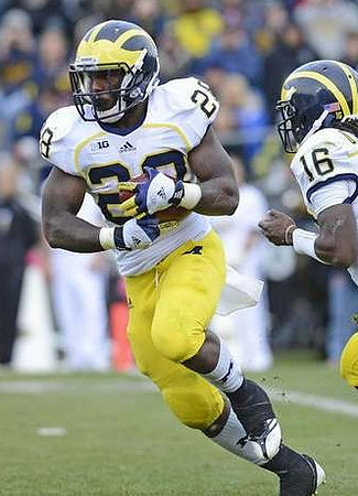 Fitzgerald Toussaint (28) and Denard Robinson (16)