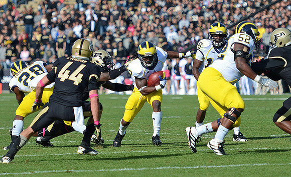 Fitzgerald Toussaint (28), Vincent Smith (2), Denard Robinson (16), and Ricky Barnum (52)