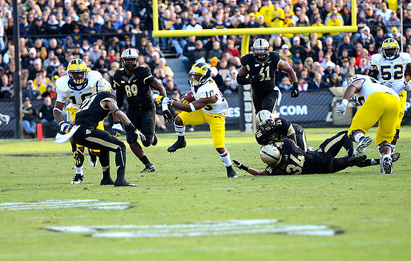 Denard Robinson (16) , Jeremy Gallon (10), Patrick Omameh (65), and Ricky Barnum (52)