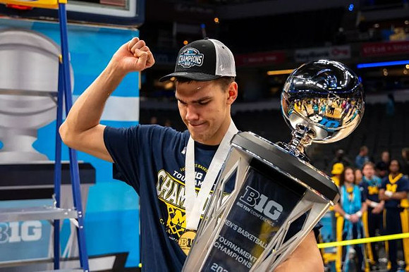 Vladislav Goldin (50) and Big Ten Tournament Championship Trophy