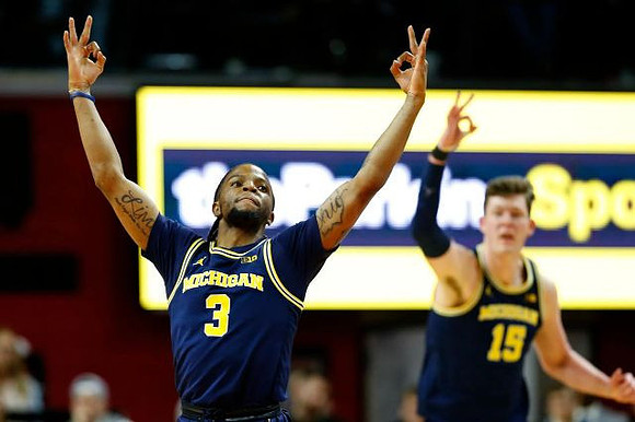 Zavier Simpson (3) and Jon Teske (15)