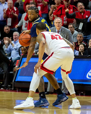 Zavier Simpson (3) and Rutgers Head Coach Steve Pikiell