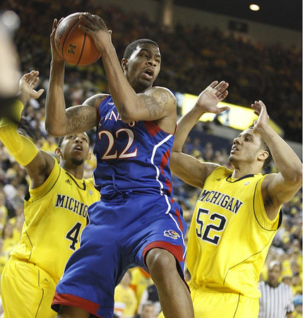 Darius Morris (4) and Jordan Morgan (52)