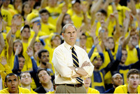 Jon Horford (15), John Beilein, and Evan Smotrycz (23)