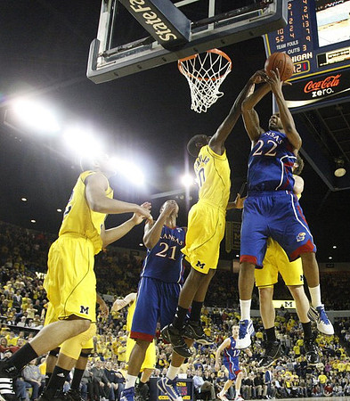 Jordan Morgan (52), Tim Hardaway Jr. (10), and Zack Novak (0)