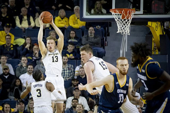 Zavier Simpson (3), Ignas Brazdeikis (13), and Jon Teske (15)