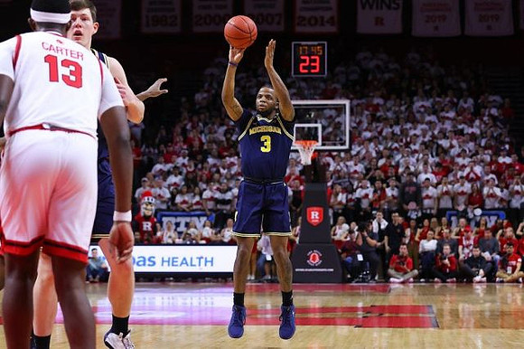 Zavier Simpson (3) and Jon Teske (15)