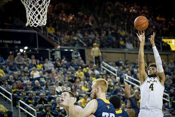 Isaiah Livers (4) and Jon Teske (15)