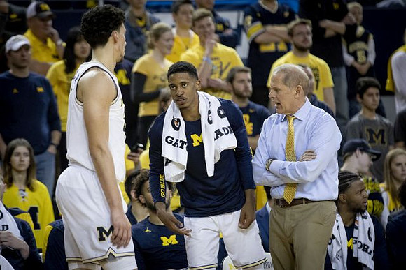 Brandon Johns Jr. (23), Charles Matthews (1), and John Beilein