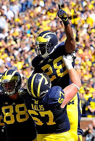 Jake Butt (88), Kyle Kalis (67), and Fitzgerald Toussaint (28)