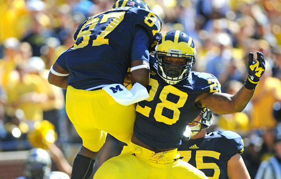 Devin Funchess (87), Fitzgerald Toussaint (28), and Michael Schofield (75)