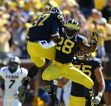Devin Funchess (87), Fitzgerald Toussaint (28), and Michael Schofield (75)