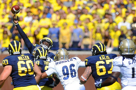 Jack Miller (60), Fitzgerald Toussaint (28), Devin Gardner (98), and Kyle Kalis (67)