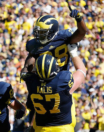 Kyle Kalis (67) and Fitzgerald Toussaint (28)