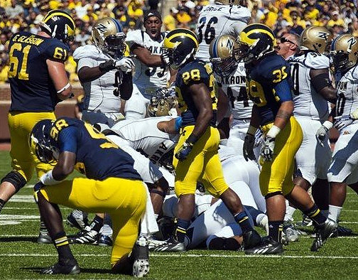 Graham Glasgow (61), Devin Gardner (98), Fitzgerald Toussaint (28), and Sione Houma (39)