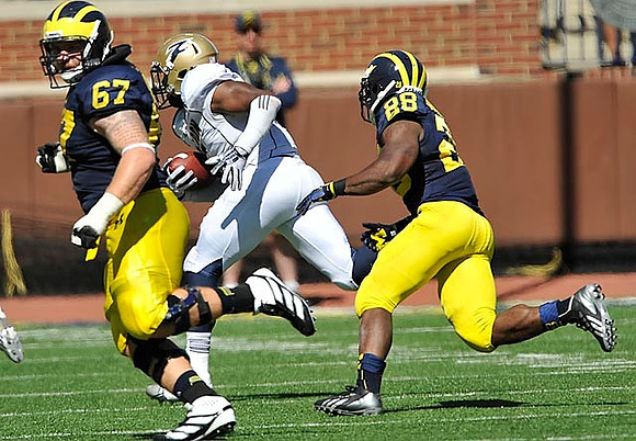 Kyle Kalis (67) and Fitzgerald Toussaint (28)