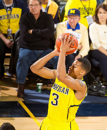 Trey Burke (3) and Lloyd Carr