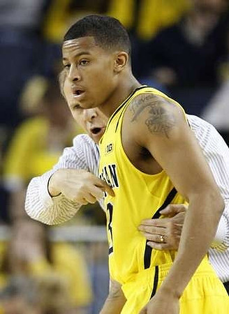 Trey Burke (3) and John Beilein