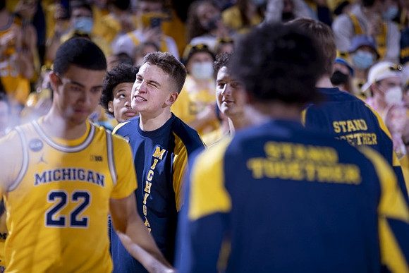 Caleb Houstan (22) and Michigan Team