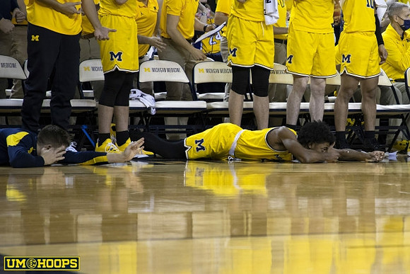 Jace Howard (25) and Michigan Team