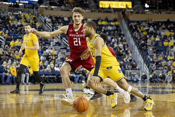 Hunter Dickinson (1) and DeVante' Jones (12)