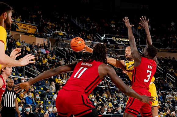 Hunter Dickinson (1) and DeVante' Jones (12)