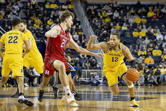 Caleb Houstan (22), Hunter Dickinson (1), and DeVante' Jones (12)