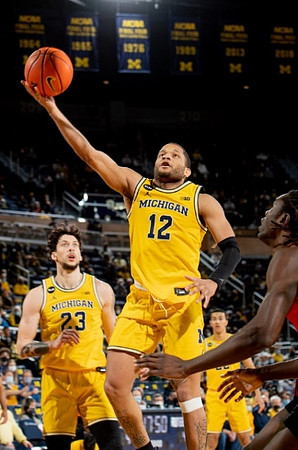 Brandon Johns Jr. (23), DeVante' Jones (12), and Caleb Houstan (22)